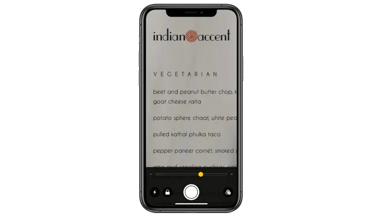 Smartphone displaying a vegetarian menu from Indian Accent restaurant