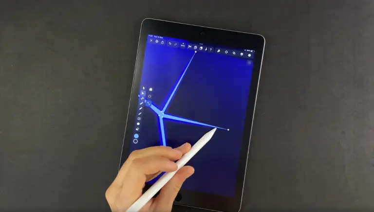 Hand with stylus adding final touches to a blue diamond illustration on a tablet