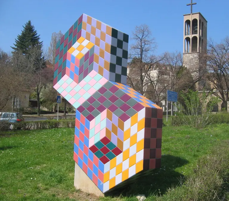 Sculpture made of cubes, covered with a colorful checkerboard pattern