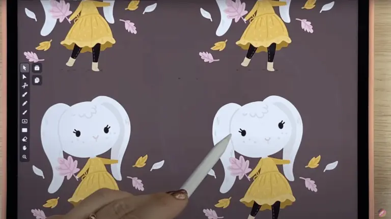 Hand with stylus over a tablet showing cartoon characters