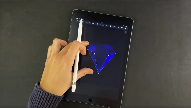 Hand holding a stylus over a tablet with a blue diamond graphic on the screen