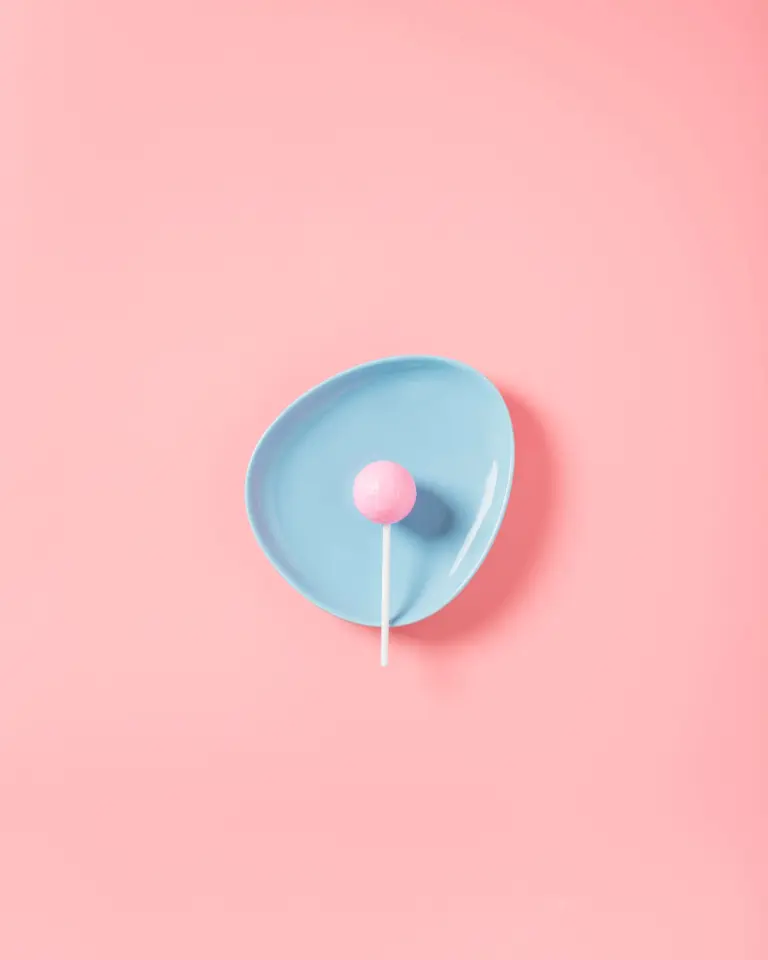 Blue Bowl With Pink Lollypop On Pink Background