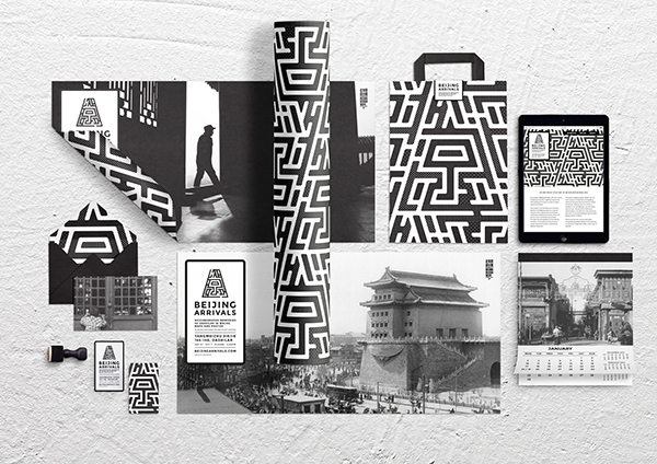 Assorted black and white printed materials with Beijing-inspired designs pinned on a wall.