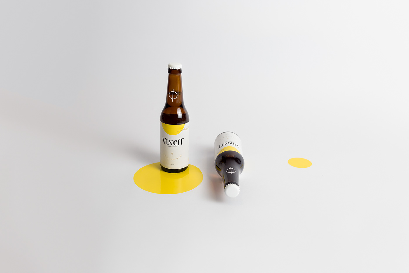 Two labeled beer bottles on a plain background with colored circles.