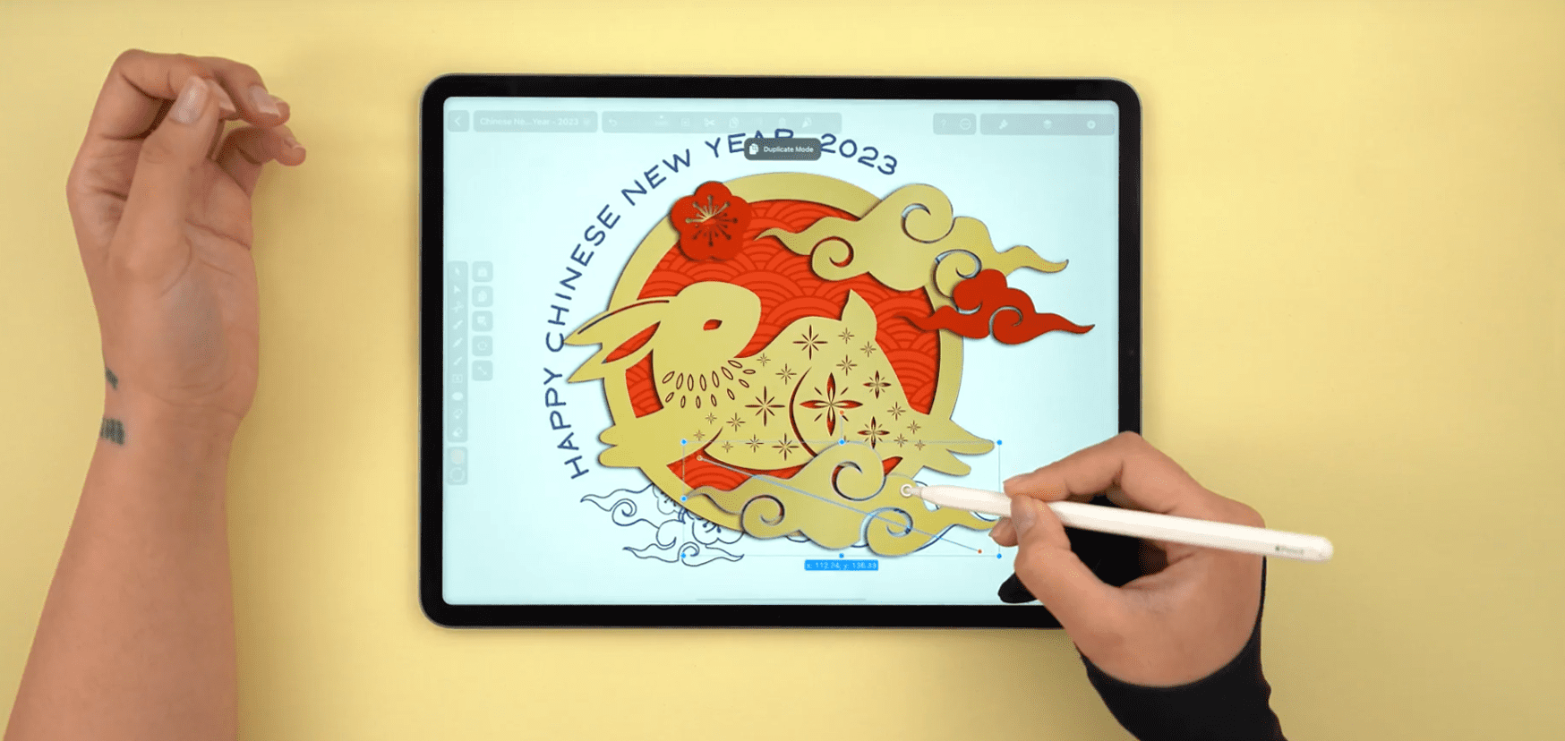 Hand adding details to a rabbit design for Chinese New Year 2023 on a tablet