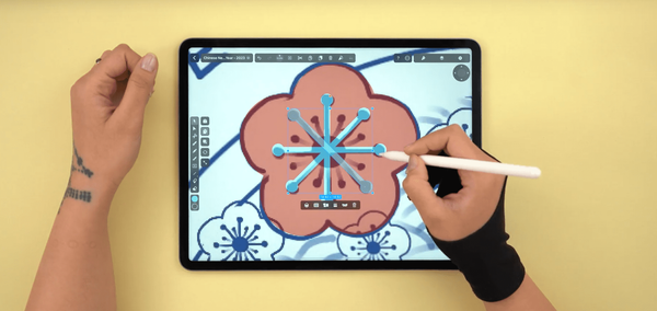 Hand drawing a plum blossom on a tablet screen