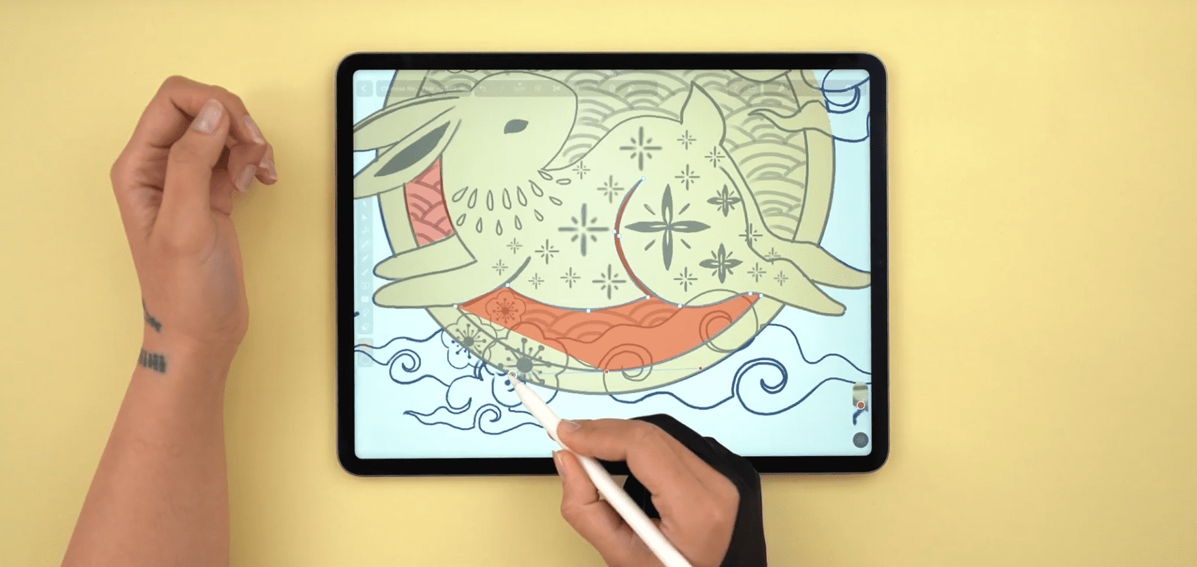 Hand sketching a rabbit on a large tablet screen