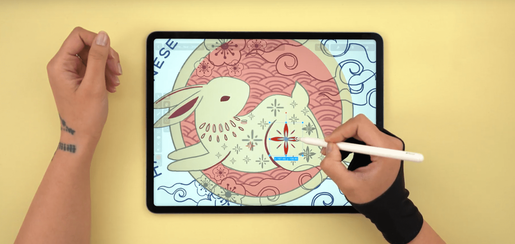 Hand drawing a rabbit with a floral pattern on a digital tablet
