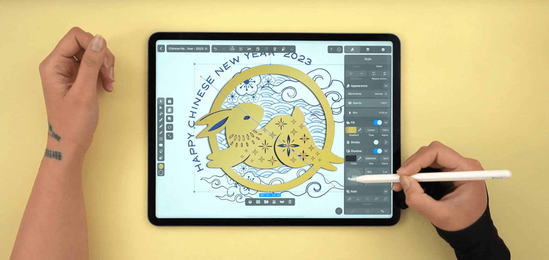 Hands editing a rabbit illustration for Chinese New Year 2023 on a tablet