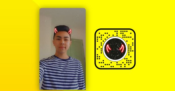 Person with animated devil horns filter next to a Snapchat code.