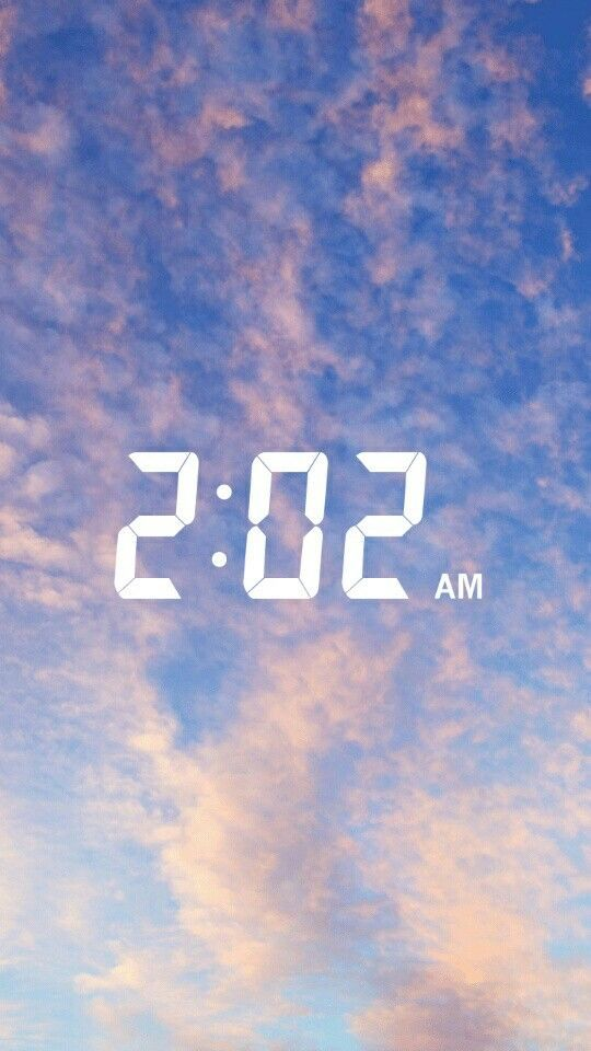 Digital clock reading "2:02 AM" over a cloudy sky background.
